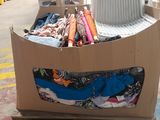 a cardboard box that has a bunch of clothes in it