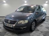 a picture of a grey volkswagen passat parked in a garage
