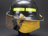 a close up of a fireman ' s helmet with a protective face mask