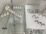 a glass display case with a lot of jewelry on it