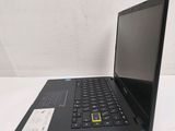 a black laptop with a yellow sticker on it