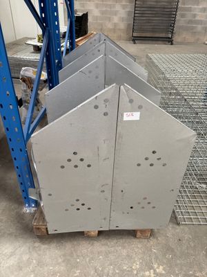 several pieces of metal on a pallet in a warehouse