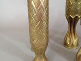 two gold vases sitting next to each other on a table