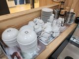 a lot of dishes and cups on the counter