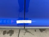 a close up of a blue car with a sticker on it
