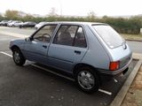 a small blue car parked in a parking lot