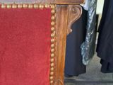 a red chair with a red cushion on it in a store