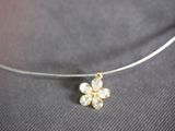 a necklace that has a flower on it on a table
