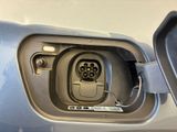 a close up of a car ' s door handle with an electric plug