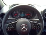 the steering wheel of a car with a clock and gauges