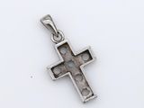 a small silver cross with holes in the middle on a white background