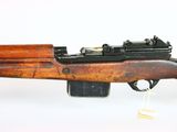 a close up of a rifle that is on a white surface