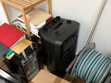 a pile of boxes and a hose in a room