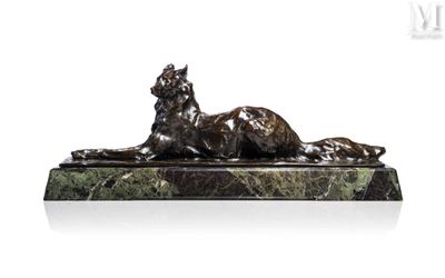 a statue of a cat laying down on a marble base