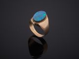 a gold ring with an oplite stone in the center
