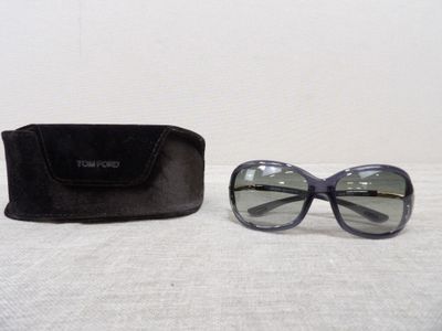 a pair of sunglasses sitting on a table next to a black case