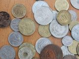 a pile of coins on a table with a coin on top of it