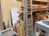 a workbench in the middle of a room with lots of wood