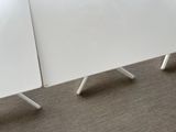 two white tables sitting next to each other on the floor
