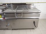 a large stainless steel fryer sitting in the middle of a kitchen