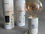 a lamp that is sitting on a table next to a box