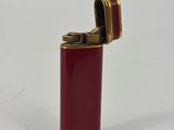 red lighter with gold trim on a white background