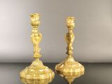 pair of antique brass candlesticks on a black table