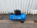 a blue air compressor sitting on the side of a building