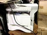 a white printer sitting on top of a pile of boxes