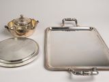 silver plated teapot, mirror and teapot on a white surface