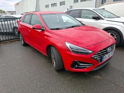 a red car parked in a parking lot next to other cars