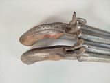 a close up of a pair of pliers on a white surface