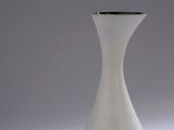 a white vase that is sitting on a table