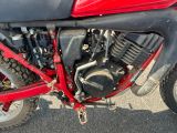 une moto rouge et noire garée sur le bord de la route