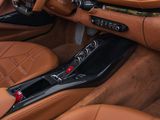 the interior of a sports car with leather seats and dashboard controls