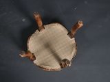 an overhead view of a wooden chair on a black surface