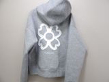 grey hoodie with white logo on it hanging on a wall