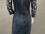 a mannequin dress with a black lace back and long sleeves