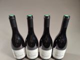 three bottles of wine are lined up on a table
