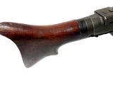 an old machine gun with a wooden handle on a white background