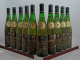 bottles of wine are lined up in a row on a table