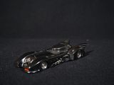 a toy car that is sitting on a black surface