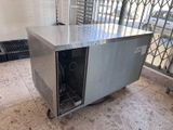 a stainless steel table with a glass door on top of it
