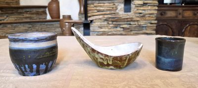 two bowls and a cup on a table in a living room