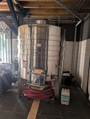 une photo d'une grande cuve en acier inoxydable à l'intérieur d'un bâtiment