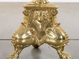 a gold plated table with a lion head on top of it