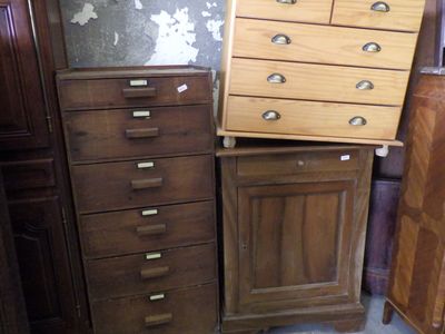 a lot of wooden drawers and cabinets in this room