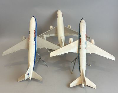 three model airplanes that are sitting on a table