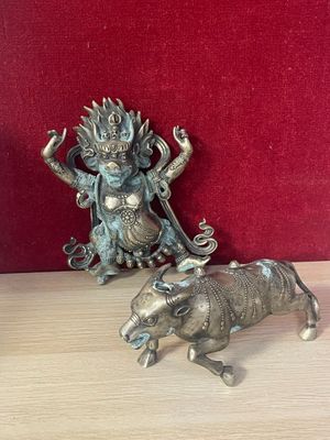 two figurines that are sitting on a table