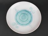 a white plate with a blue design on it